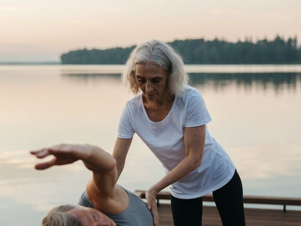 Person stretching gracefully during sunrise, feeling energized.